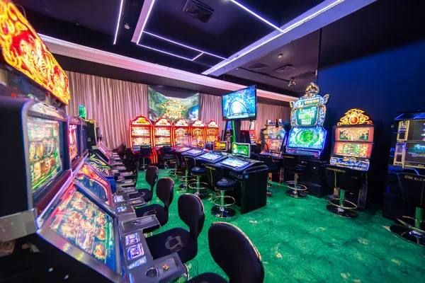 A man celebrating a winning moment on his laptop while gaming symbols float around him, capturing the excitement of CB44 games.